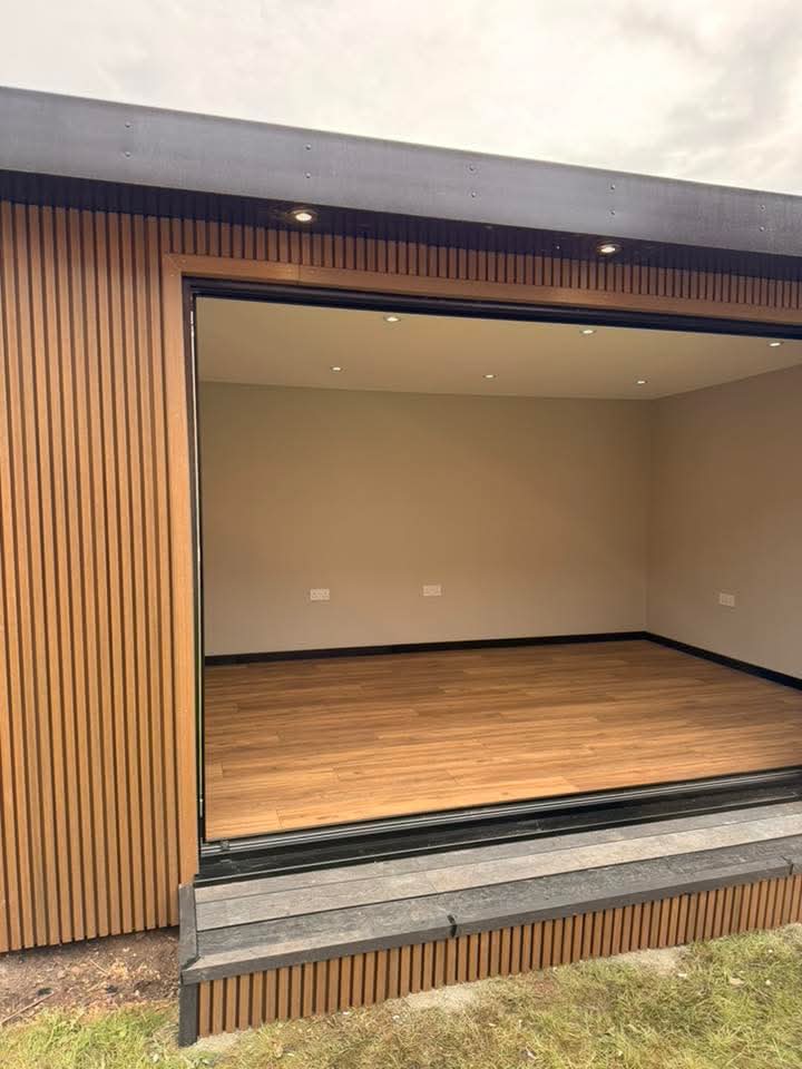 Garden studio interior — finished floor, spotlights and open bifold doors